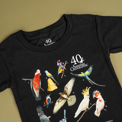 Black t-shirt with colorful bird illustrations and 40 Australian Geographic logo on a beige background