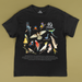 Black t-shirt with colorful bird illustrations and '40th Anniversary Geographic' design on a beige background