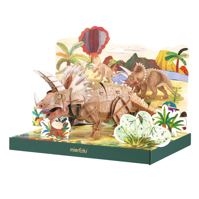 Dinosaur toy set in a colorful box with palm trees and plants on a white background