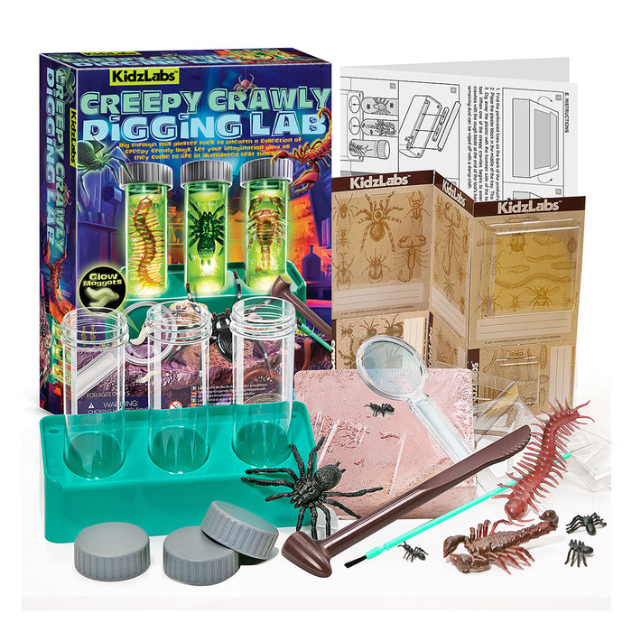 KidzLabs Creepy Crawly Digging Lab kit with its colorful retail box, instruction booklet, clear plastic vials, teal tray, gray caps, magnifying glass, wooden scoop, and various toy insects and spiders arranged on a white background.