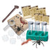 A children's science exploration kit laid out on a white background, including plastic insects, a magnifying glass, labeled sample cards, a wooden pestle, a green specimen holder, and other educational accessories.
