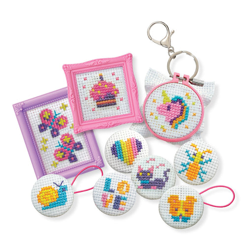 Cross-stitched keychains and frames on a white background