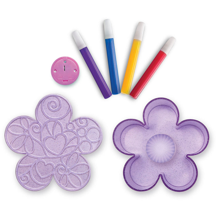 Flower-shaped cutters with colorful handles on a white background