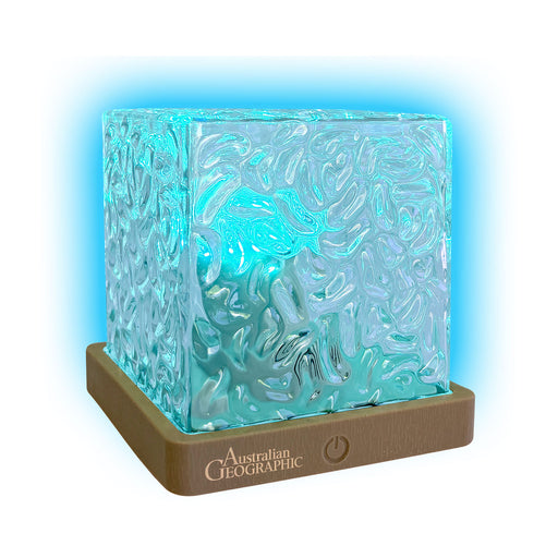 Decorative lamp with wavy glass design and brown base, featuring 'Australian Geographic' branding.