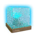 Decorative lamp with wavy glass design and brown base, featuring 'Australian Geographic' branding.