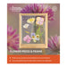Flower press & frame product with Australian Geographic branding against a floral background