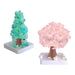 Two decorative trees, one green and one pink, on white bases with a white background.