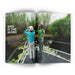 Open magazine showing two people on a boat with text 'Bird is the Word' in a natural setting.