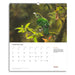 Calendar page for February 2026 featuring a green bird on a branch with a blurred natural background.