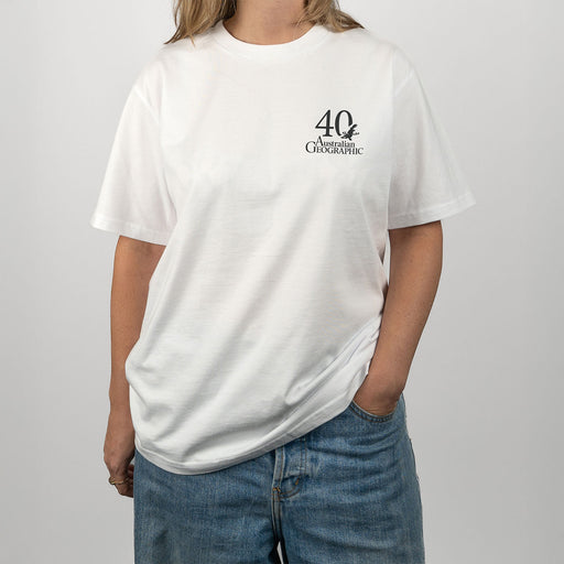 Person wearing a white t-shirt with a logo on a plain background