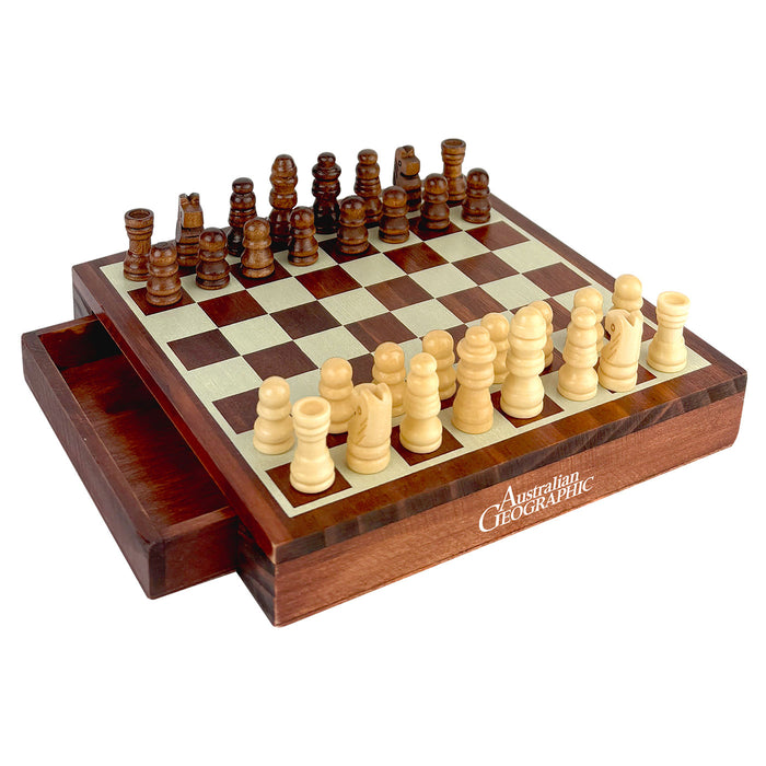 A wooden chess set with a sliding drawer base, featuring dark and light checkered boards and ivory and dark brown chess pieces. The brand name 'Australian Geographic' is printed on the front of the wooden base.