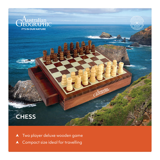 Australian Geographic branded chess set shown on a rocky coastal cliffside background, with wooden chess pieces and a folding wooden board. Text on the image includes 'Australian Geographic', 'CHESS', and product selling points about a two-player deluxe wooden game and compact size for travelling.