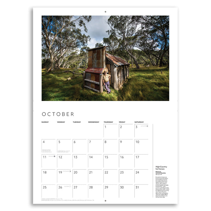 Calendar page for October showing a rustic cabin in a forest