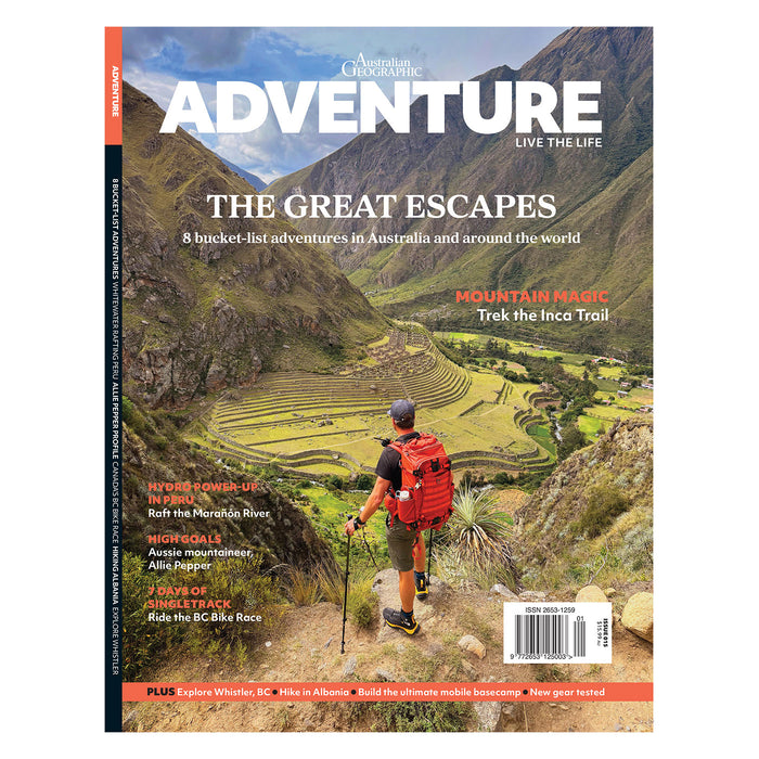 Magazine cover featuring a hiker on a mountain trail with scenic landscape
