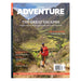 Magazine cover featuring a hiker on a mountain trail with scenic landscape