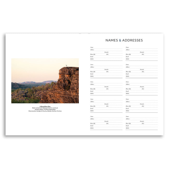 A printed stationery page or planner insert with a scenic landscape photo on the left and multiple address/name fields labeled 'Names & Addresses' on the right, shown on a white background.