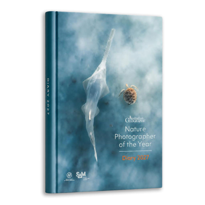 Australian Geographic Nature Photographer of the Year Diary 2021, featuring a blue-toned cover with a translucent sea slug and a small brown organism, shown standing upright against a white background.