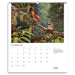 A spiral-bound November 2027 wall calendar page featuring a large bird photograph of two brown birds perched on branches in a lush green forest. The calendar includes a date grid and a short caption at the bottom right.