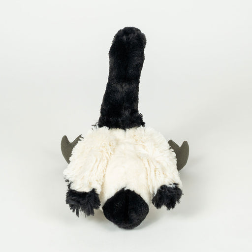 A black and white fluffy stuffed animal toy, photographed from the back against a clean white background.