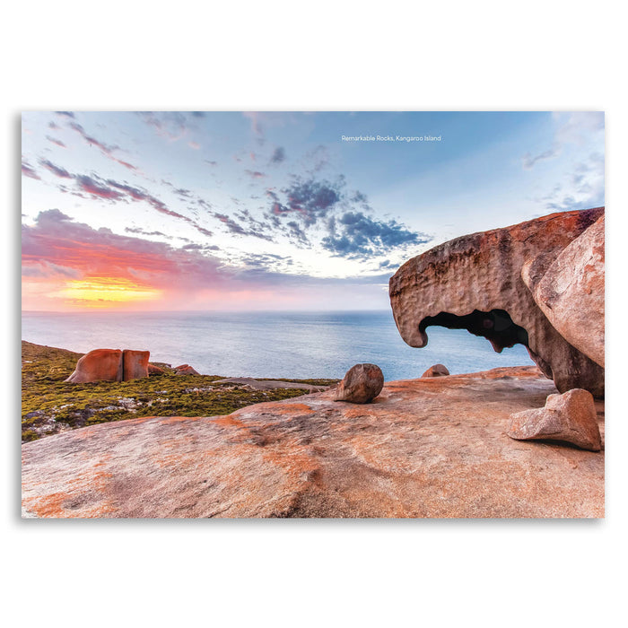A rectangular wall art print showing a coastal rock formation at sunset over the ocean, with small text at the top reading 'Homerickula Rocks, Kangaroo Island'. The print is photographed against a clean white background.