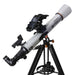 Telescope with a white tube and black tripod on a white background