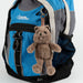 Blue backpack with a quokka bear keychain on a white background