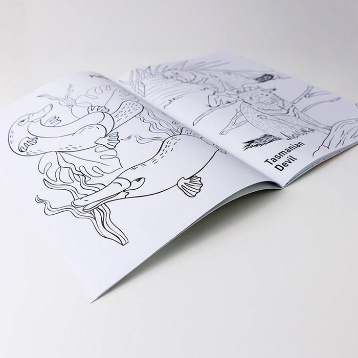 Open coloring book with illustrations of a Tasmanian Devil on a white surface