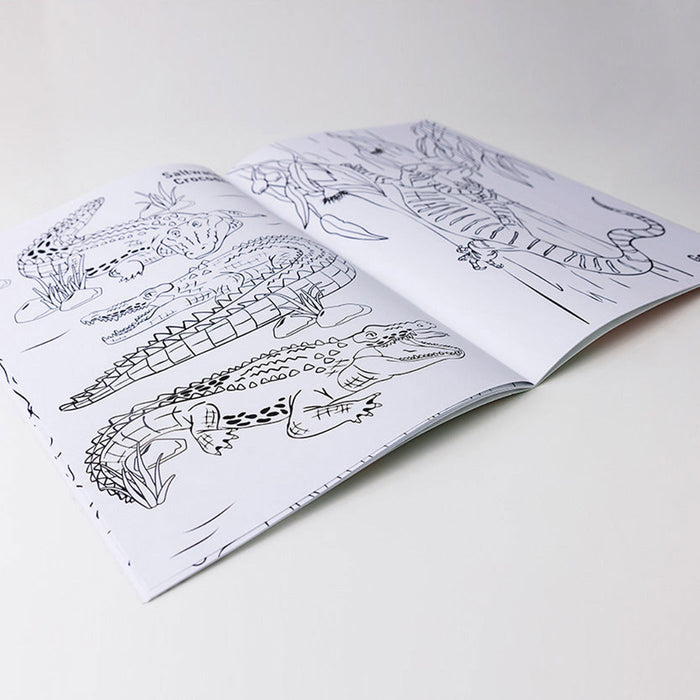 Open coloring book with animal illustrations on a white surface