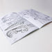 Open coloring book with animal illustrations on a white surface