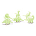 Set of glow-in-the-dark dinosaur toys on a white background