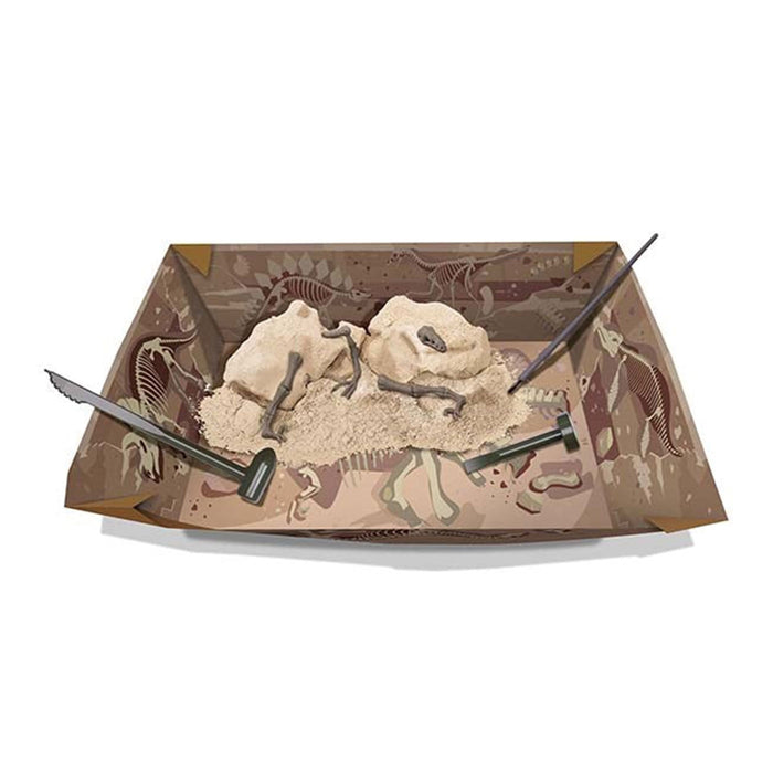 Dinosaur excavation kit with tools and sand on a white background