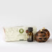 Aromatherapy products including a box, bottle, and wooden diffuser on a white background