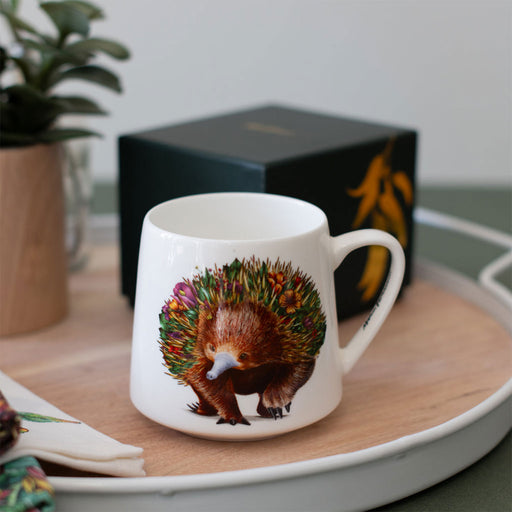 White mug with a echidna design on a wooden surface