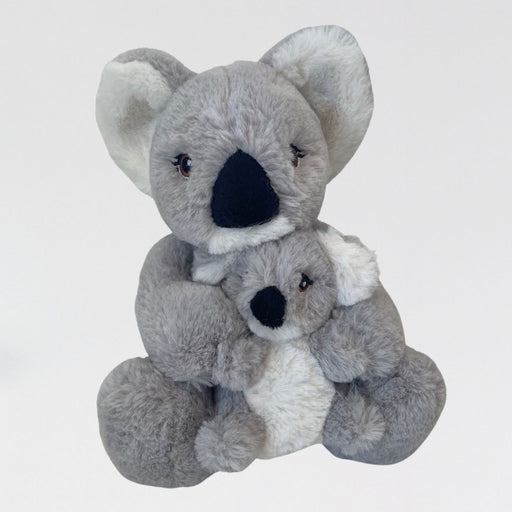 Two plush koala toys stacked on a light gray background