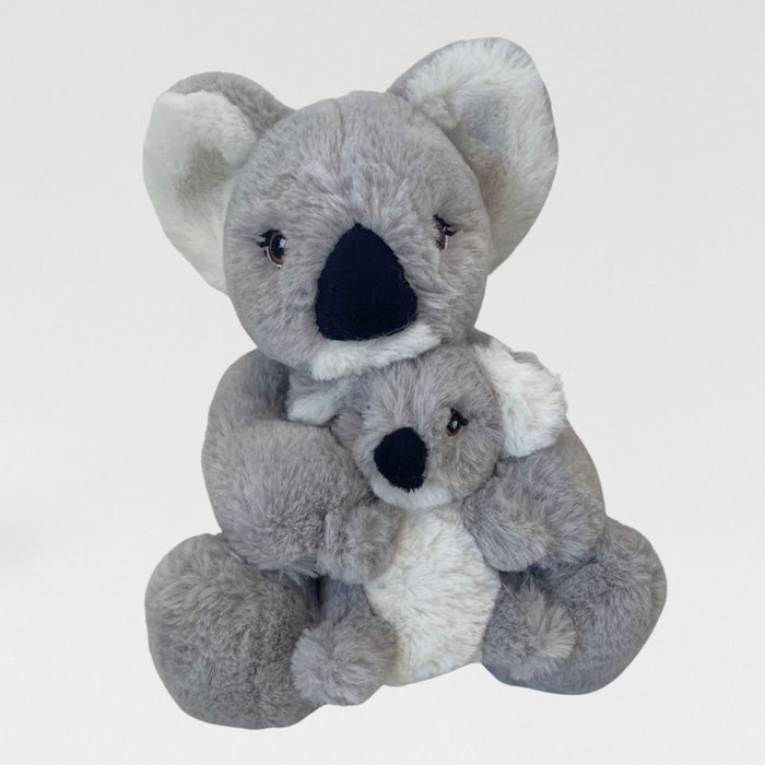 Two plush koala toys stacked on a light gray background