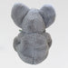 Gray plush elephant toy on a light gray background