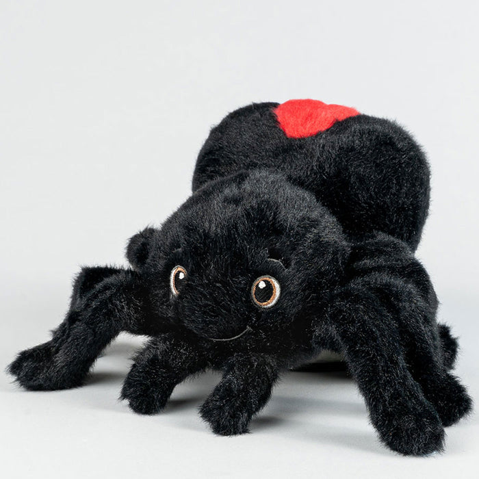 Black plush spider toy with a red spot on a white background