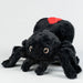 Black plush spider toy with a red spot on a white background