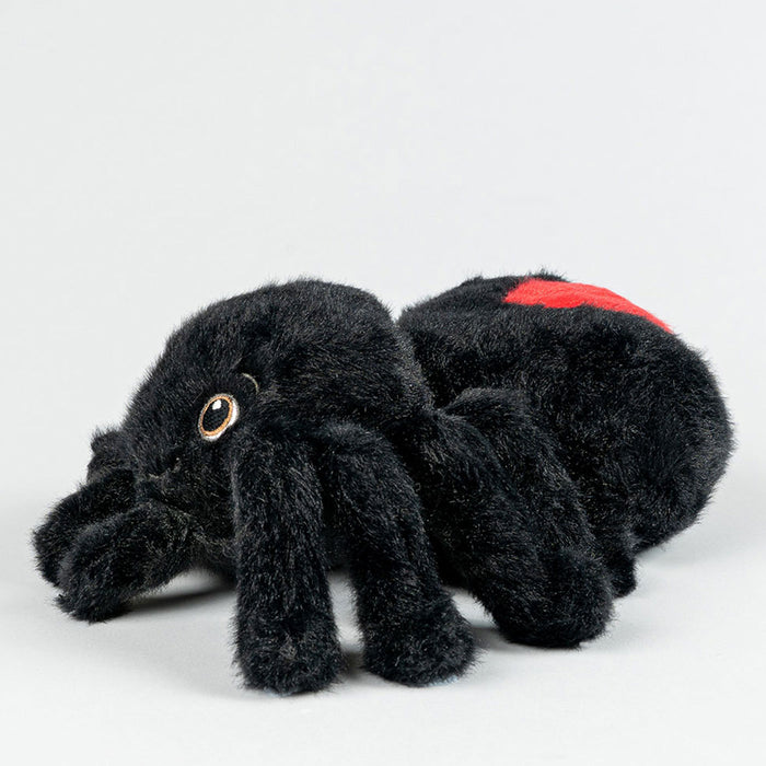 Black plush spider toy with a red spot on a white background