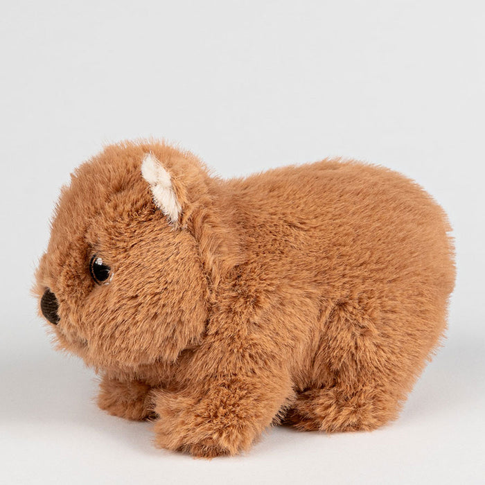 Brown plush wombat toy on a light grey background