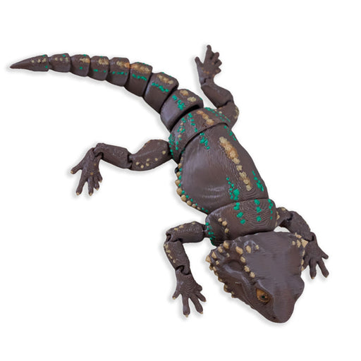 Toy bearded dragon figure on a white background