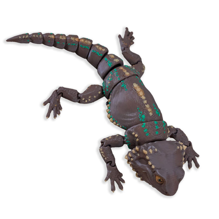Toy bearded dragon figure on a white background