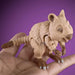 Toy quokka figure on a hand with a purple background