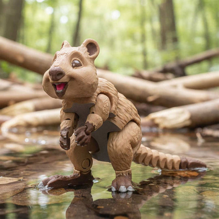 Toy quokka figure standing in water with a forest background
