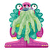 Toy figure of a character with green gooey substance on a white background