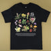 A black short-sleeve graphic t-shirt featuring a colorful botanical illustration of Australian flowers and plants, with the text '40th Anniversary' and 'Australian Geographic' printed on the chest, laid flat on a beige background.