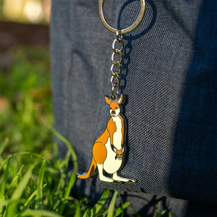 Kangaroo keychain attached to a bag with grass in the background