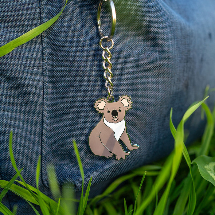 Keychain with a koala design on a grassy background