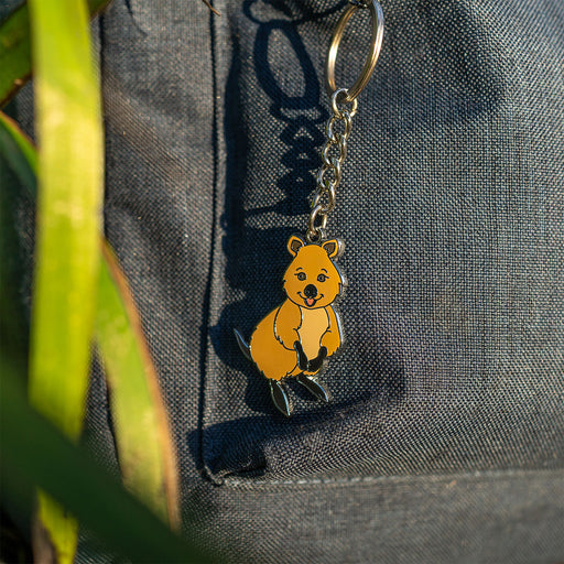 Keychain with a quokka design attached to a textured surface