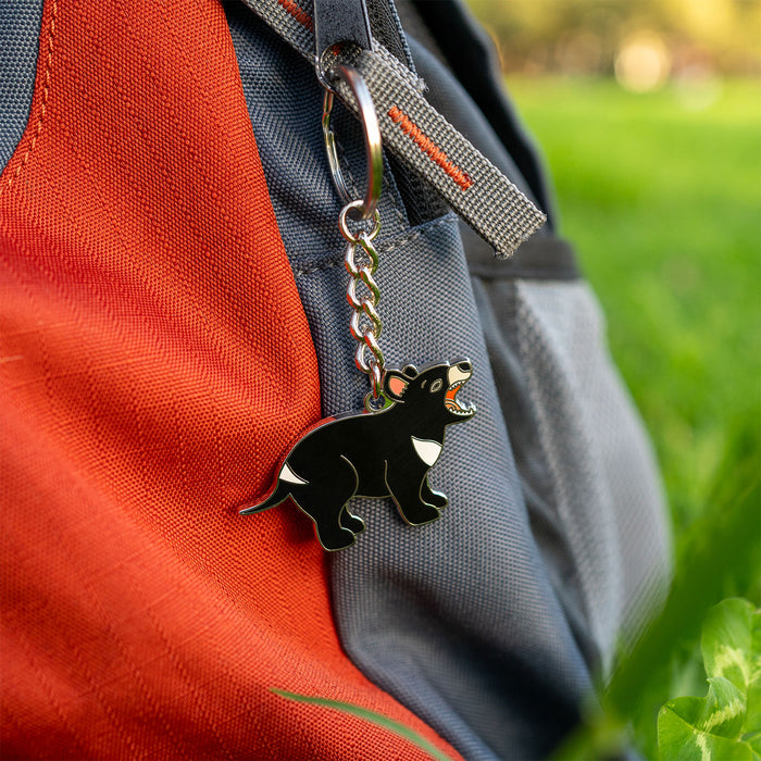 Tasmanian devil keychain attached to a backpack with a natural background